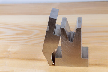 Bending tool on a wooden background. Sheet metalworking cnc press brake bending tool.