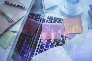 Multi exposure of financial chart drawing over table background with computer. Concept of research and analysis. Top view.