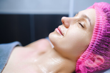 Close-up woman face in beauty spa on couch. Relaxation, rejuvenation