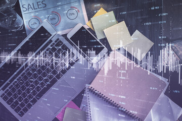 Financial market graph and top view computer on the desktop background. Multi exposure. Investment concept.
