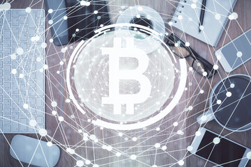 Double exposure of blockchain theme hologram over table with phone. Top view. Crypto technology concept.