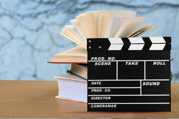 Set od books and Movies slate on the desk