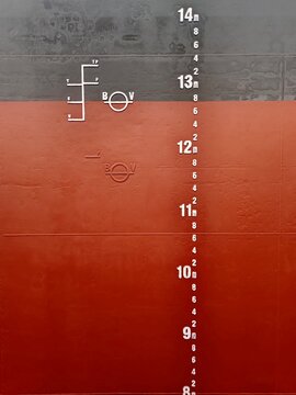 A mid draft mark, load line and plimsoll mark on a side of cargo ship or bulk carrier