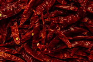 Red, dried bird's eye chili or Thai chilli peppers with seeds, hot and spicy Capsicum for sambal, chile sauces, pastes, marinades and as condiment for cooking Asian cuisine dishes, close-up macro shot - 531805391