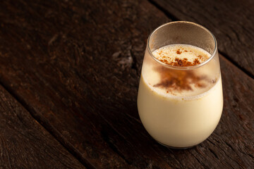 Eggnog cup with cinnamon powder.