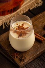 Eggnog cup with cinnamon powder.