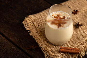Eggnog cup with cinnamon powder.
