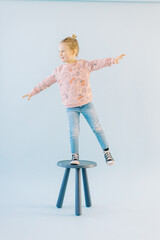 Girl balancing on chair