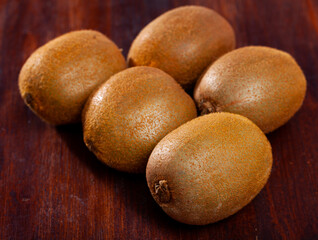 Image of fresh tropic fruit kiwi on wooden surface