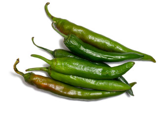 Fresh green chili peppers. Spicy vegetable isolate. Peppers on a white background. Ingredient for dishes. The concept of spicy food. Fresh chili pepper. Harvesting vegetables for seasonings.