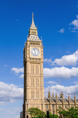 Big Ben, the clock tower on the background of the blue sky