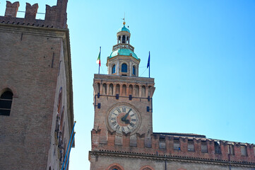 Bologna, Italy. Piazza Maggiore, main square in the city. Bologna is capital of the Emilia-Roma region. Clock tower. 