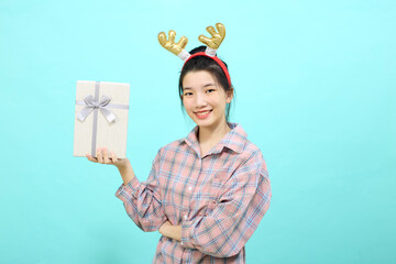 girl holding gift box and looking at camera