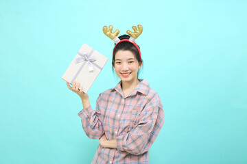 girl holding gift box and looking at camera