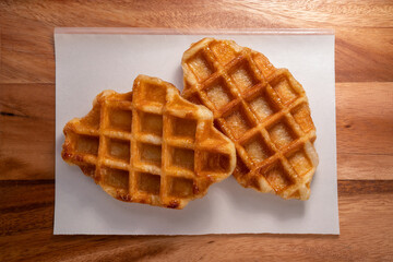 Waffle in wooden plate on wooden table, Freshly baked Waffle on brown wooden table.