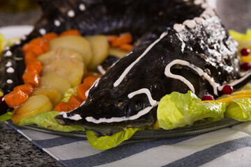 Dish of fried sturgeon with a vegetable servit at table..