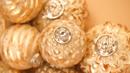 Christmas balls background.Golden christmas texture.Festive shiny background in Gold tones.design Christmas decorations.Christmas toys in a minimalistic style and monochrome color. 
