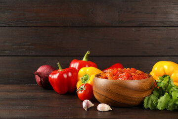 Tasty lecho and fresh ingredients on wooden table. Space for text