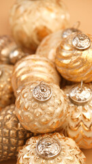 Christmas balls background.Golden christmas balls set.Christmas tree decorations texture.Festive shiny background in Gold tones.Christmas toys in a minimalistic style and monochrome color. 