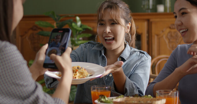 Asia Teen Girl Vlogger Talk Show Share On Viral Vlog Fun Speak Smile Look Camera For IG Reel Instagram Tiktok Mobile App. Gen Z Youth People Enjoy Eat Happy Meal On Modern Vegan Retail Cafe Table.