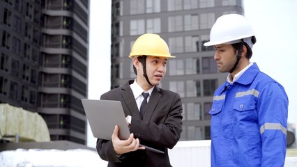 Professional Asian foreman and construction manager talking - discussing about building structure plant.