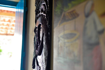 Fototapeta na wymiar dark wood carving with image of jesus christ hanging on the wall, brazilian handicraft