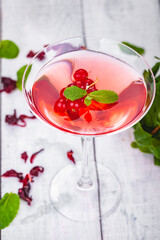 Jelly with red currant  in martini glass on wooden background. Close up