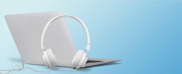 Modern headphones and laptop. Listen podcast or music concept.