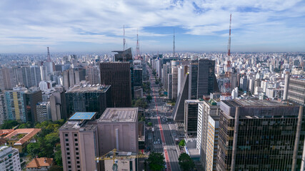 Fototapeta na wymiar Aerial view of Av. Paulista in São Paulo, SP. Main avenue of the capital. With many radio antennas, commercial and residential buildings. Aerial view of the great city of São Paulo.