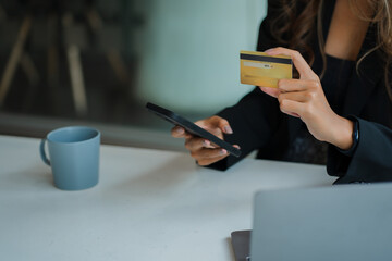 woman using smartphone Pay and hold credit card online shopping.