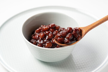 Boiled azuki beans placed on a white background.