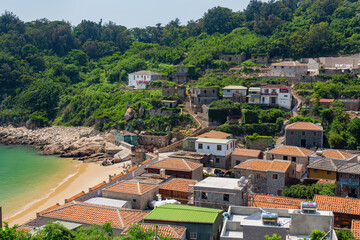 Fototapeta na wymiar Sunny view of the Jinsha Village cityscape with beach view
