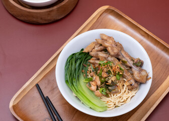 Mie ayam ceker (Chicken noodle with tasty chicken feet), Indonesian street food consist of noodle, vegetables, chicken meat and chicken feet. Popular food in the country