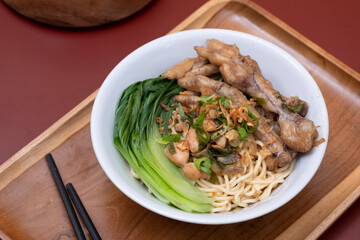 Mie ayam ceker (Chicken noodle with tasty chicken feet), Indonesian street food consist of noodle, vegetables, chicken meat and chicken feet. Popular food in the country