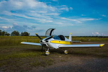 commercial airport for private small planes that can be used to practice flying to become a trainee pilot to fly to travel, deliver goods, or fly as a hobby There is a machine on orange and yellow 