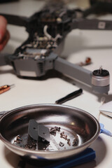 close up of different repairing tools and a drone, on white table