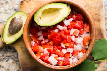 Top view of a tomato salad with avocado 