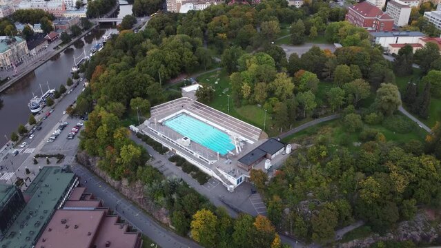 Outdoor swimming pool in a park. Drone shot