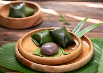 Kue Bugis, Indonesian traditional snacks and dessert made from rice flour filled with sweet grated coconut called enten in sundanese.It usually wrap in banana leaf with triangle shape. Selective Focus