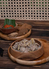 Indonesian coconut milk soup called sayur jantung pisang, made with banana's heart (ontong), coconut milk, cayenne pepper, and other spices . This one was served in a wooden bowl.