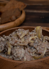Indonesian coconut milk soup called sayur jantung pisang, made with banana's heart (ontong), coconut milk, cayenne pepper, and other spices . This one was served in a wooden bowl.