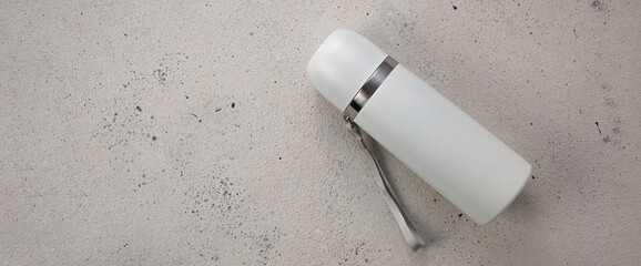 Thermos for drinks on gray background, top view, banner, place for text