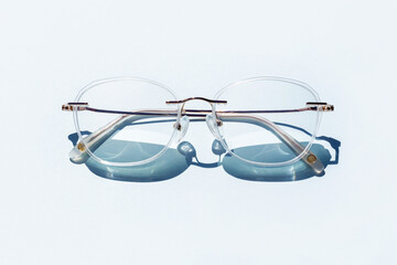 Eye Glasses with strong shadows on blue background