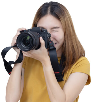 View of Asian Female Photographer Looking into Mirrorless Camera Viewfinder to Take Photos+