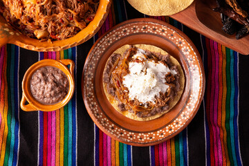 Tostada de Tinga de Res. Typical Mexican dish prepared mainly with shredded beef, onion and dried...