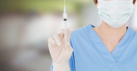 Mid section of female doctor in hospital with coronavirus vaccine