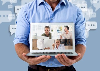 Mid section of man holding a laptop with screen showing video call self isolating at home d