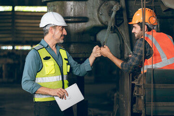 Caucasian factory engineer talking and shaking hands on business cooperation agreement. Successful...