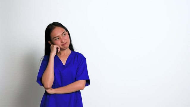Young Female Nurse Having a Though Over Something at a White Background