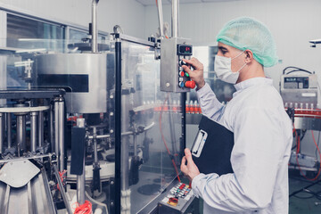 food and drink factory engineer  staff worker operate machine at production line. beverage products...